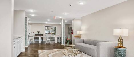 A modern living room with a sofa, a coffee table, and a patterned rug.