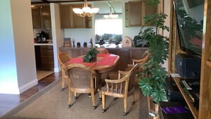 A dining area with a wooden table, chairs, and a chandelier. - Neat Retreat, Fast WiFi, Ski Sipapu, Hike, Fish, Hunt,
Wineries, pet friendly  (Penasco)