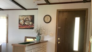 A reception area with a wooden reception desk, a clock on the wall, and a ceiling fan. - Neat Retreat, Fast WiFi, Ski Sipapu, Hike, Fish, Hunt,
Wineries, pet friendly  (Penasco)