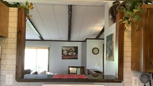 A kitchen with a built-in oven, a clock, and a window with a view of the outdoors. - Neat Retreat, Fast WiFi, Ski Sipapu, Hike, Fish, Hunt,
Wineries, pet friendly  (Penasco)
