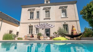 A large building with a swimming pool in front. - Adorable apartment located in a castle (AVOINE)
