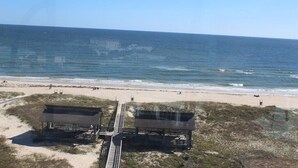 A beach with two wooden structures, a sandy path, and the ocean in the background. - SEASHELL ESCAPE - Pool & Beach Front 2 Bedroom sleeps 6 - Enjoy!!! (St. George Island)
