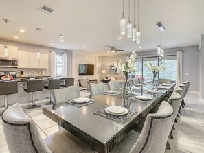 Enjoy meals in this stylish dining area with a long table and modern chairs.