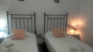 Two single beds with headboards, a bedside table, a lamp, and a small nightstand. - WINTER LONG STAY.  OASIS IN CABO DE GATA (El Pozo de los Frailes)