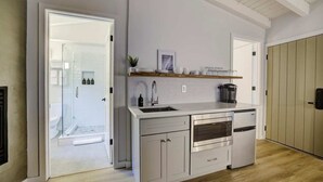 A modern kitchen with white cabinets, a stainless steel oven, and a wooden countertop. - South Lake Chalet #5 (South Lake Tahoe)