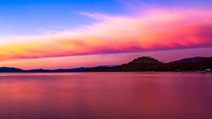 A calm lake with a mountain in the background during sunset. - South Lake Chalet #10 (South Lake Tahoe)