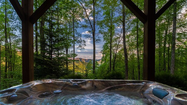 A hot tub in a forested area with a view of mountains in the background. - Patriot's Point Secluded Vacation escape (Bryson City)
