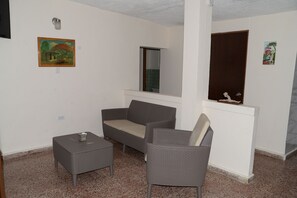 Relax in this cozy space with a gray sofa, armchair, and ottoman.
