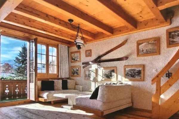 The living room, designed with an alpine theme, is located in front of the balcony.