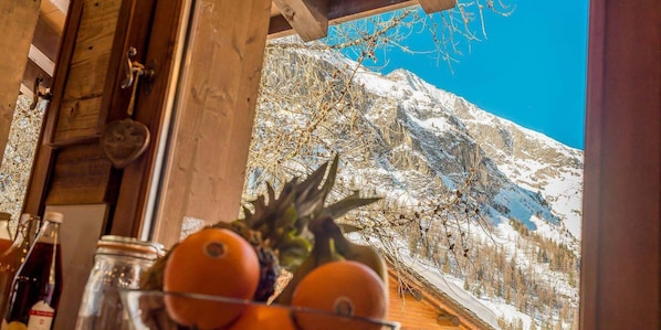 Enjoy a serene mountain view from the comfort of this cozy space.