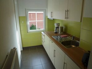 Fridge, stovetop, dishwasher, coffee/tea maker