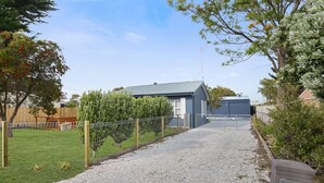 A residential property with a gravel driveway leading to a house with a grey roof. - Wild Rose Studio, 100M to the water (Goolwa South)