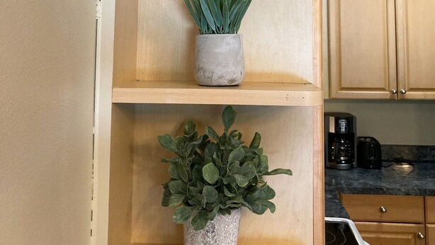 A kitchen with wooden shelves holding potted plants. - 2 Story Townhouse walk to Atlantic Ave (Delray Beach)