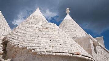 A building with conical white roofs and a clear sky.