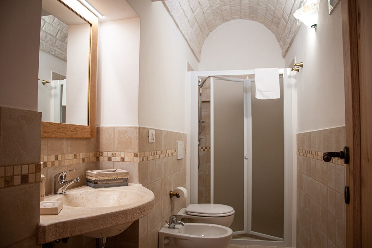 A bathroom with a sink, toilet, and shower.