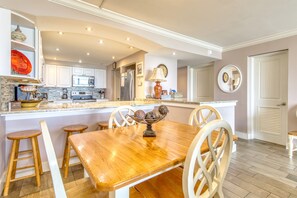 Enjoy cooking in this well-equipped kitchen with a central island and stainless steel appliances.