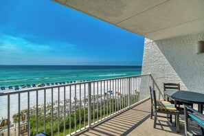 A balcony with a view of the beach and ocean. - B405 | Beachfront with Beach Service, Pool, & WiFi (Miramar Beach)