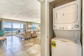 Enjoy ocean views from the spacious balcony with a table, chairs, and bench, perfect for relaxation or dining.