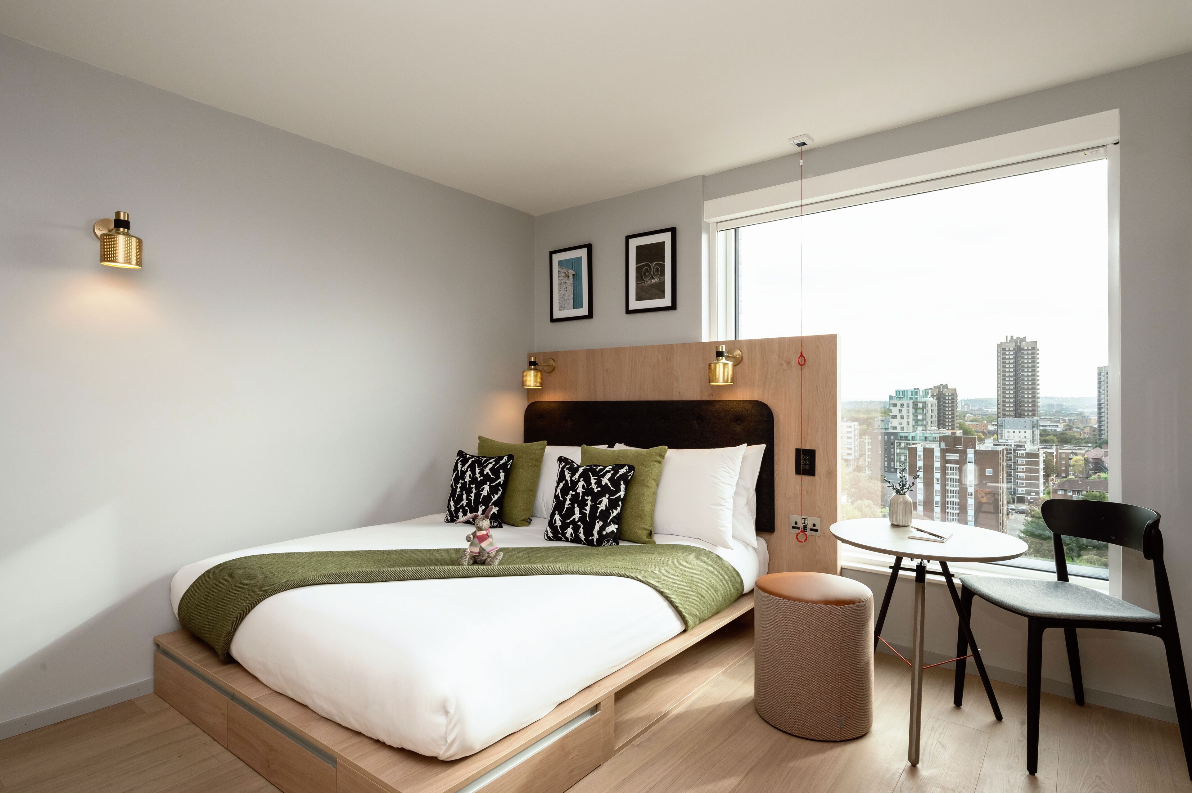 A modern bedroom with a bed, a small table, and a chair.