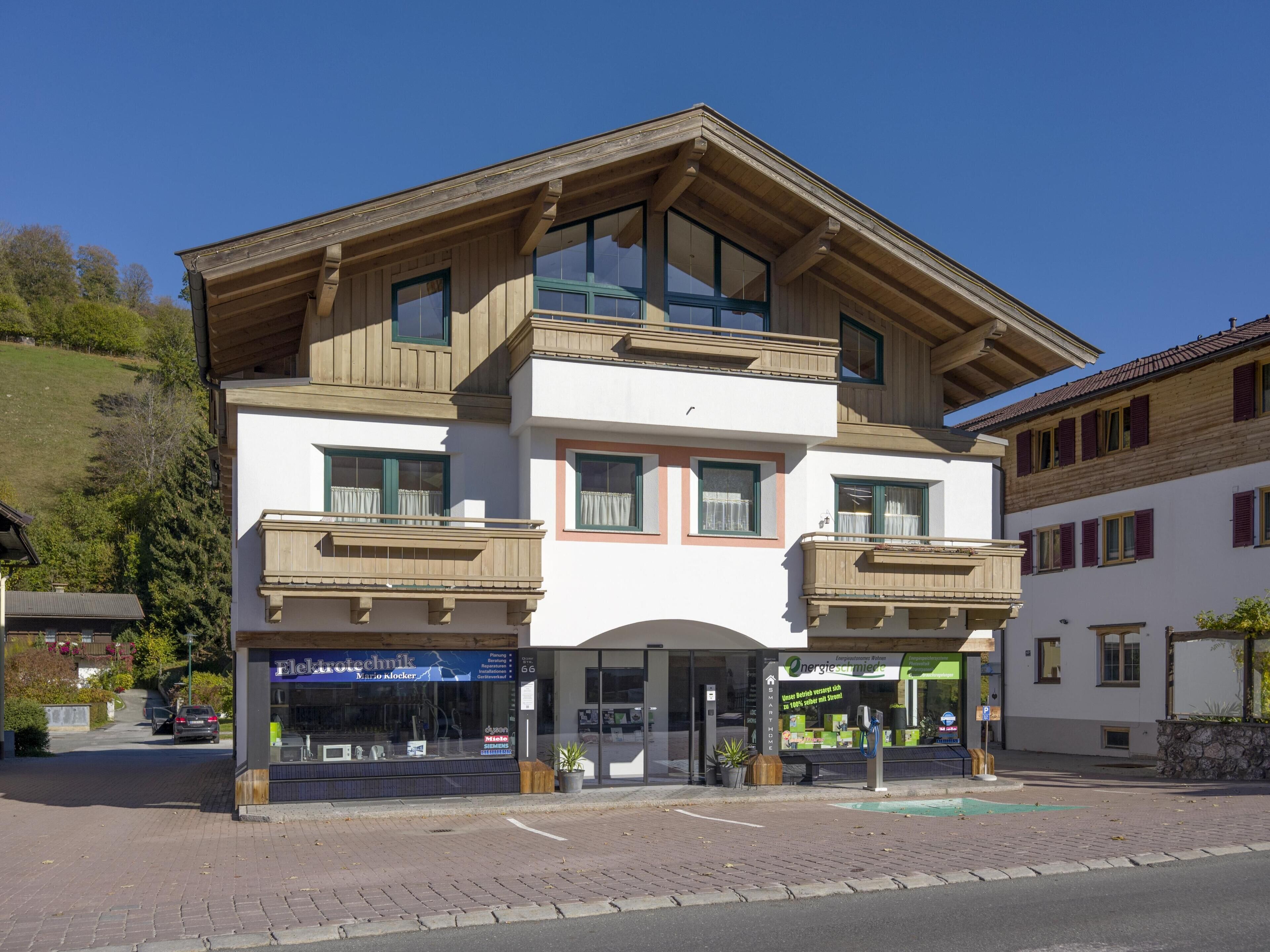 A two-story building with a ground-level shop and upper-level balconies.