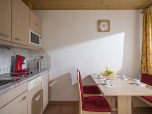 Enjoy meals in the kitchen area with a dining space, featuring a microwave, coffee maker, and sink with a modern faucet.