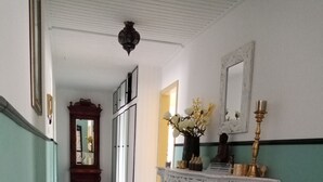 A hallway with patterned tiles, a white console table with decorative items, and a mirror on the wall. - New apartment at the market place Lieser Moseloefer 30 meters (Lieser)