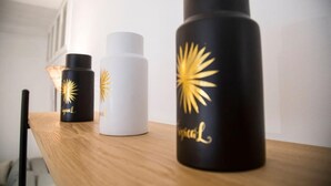Three bottles with gold designs on a wooden surface. - Apt Moderne Face au Parc et au c ur de la Marsa (La Marsa)