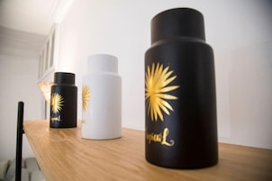 Trois bouteilles ornées de motifs dorés, posées sur une surface en bois.