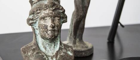 Two bronze sculptures on a black surface.