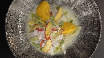 A bowl of soup with various vegetables and a clear broth.