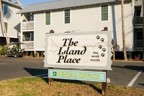 Señal de 'The Island Place' con un letrero de oficina de alquiler debajo.