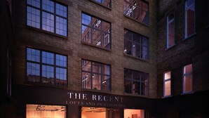 A building with multiple windows and a sign that reads "THE RECENT LOFTS AND PENTHOUSES". - Regent Style Soho Loft - Best of Both Worlds (London)