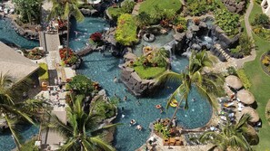 A tropical resort with multiple swimming pools, lush greenery, and outdoor seating areas. - 2-Bedroom Villa with 3 Gorgeous Lagoons = Perfect Hawaii Vacation!!! (Kapolei)