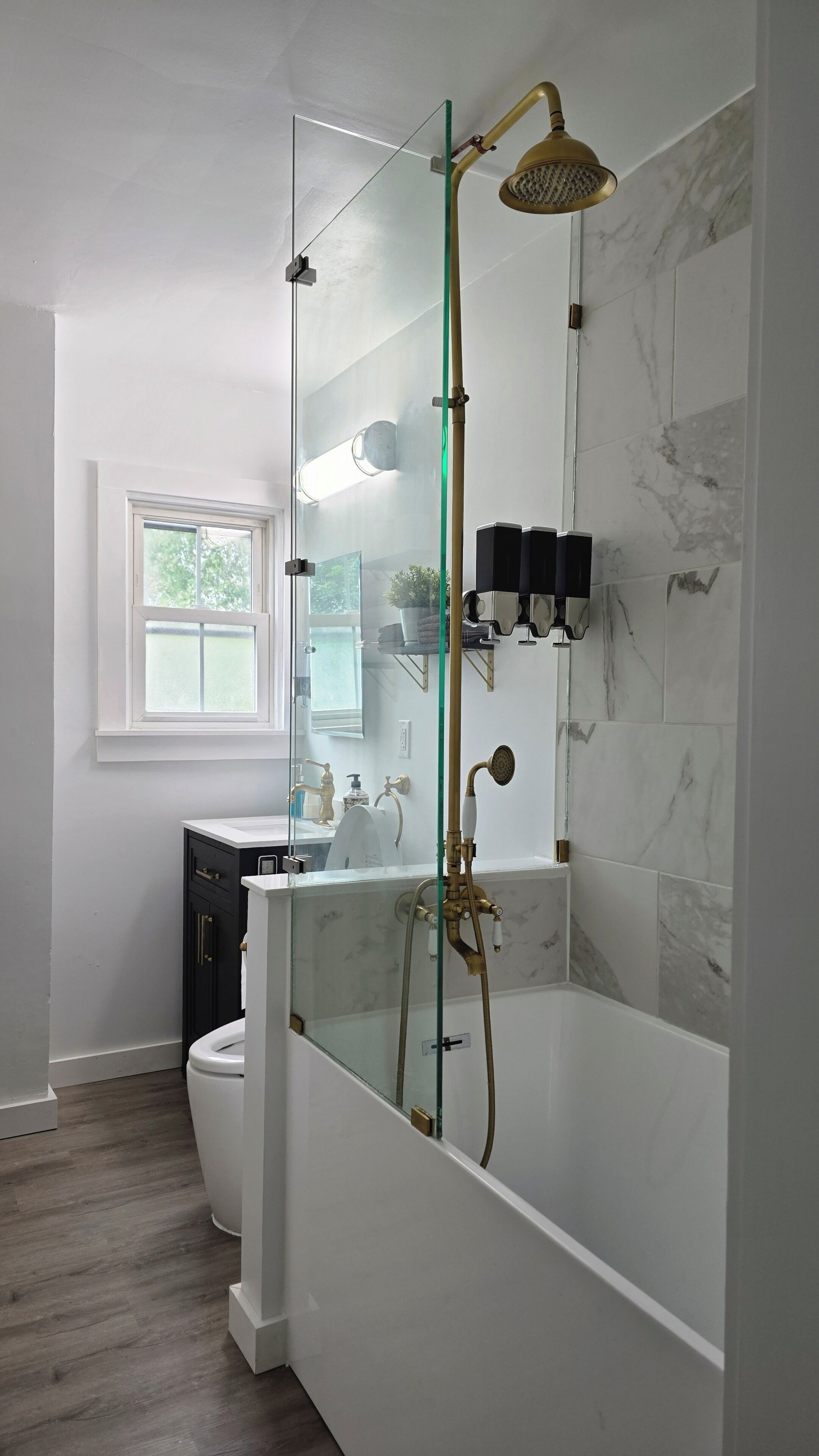 Combined shower/bathtub, hair dryer, towels, toilet paper