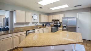 A modern kitchen with granite countertops, stainless steel appliances, and light wood cabinets. - Fresh, Clean & Comfortable Place in Round Rock (Round Rock)