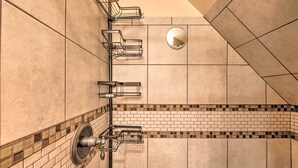 A bathroom with a tiled floor, a shower area, and a mirror on the wall. - 'Casa Verde' Cabin w/ Fire Pit: 4 Mi to Ski (Cloudcroft)