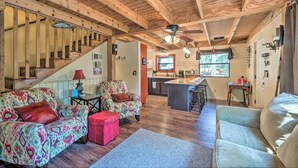 A spacious living area with a wooden ceiling, a staircase, a kitchen, and a dining area. - 'Casa Verde' Cabin w/ Fire Pit: 4 Mi to Ski (Cloudcroft)