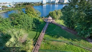 A park with a gazebo, a walking path, and a lake.