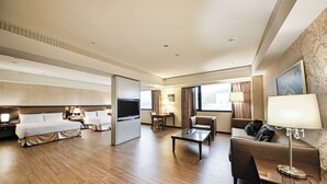 A hotel room with a bed, a TV, a desk, a chair, and a sofa. - CHECK inn Taipei Neihu (Taipei)