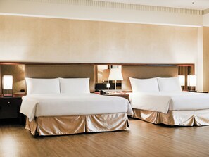 A hotel room with two beds, wooden flooring, and a headboard with a light fixture. - CHECK inn Taipei Neihu (Taipei)