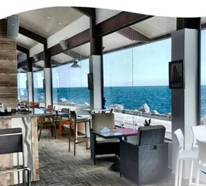Enjoy a casual dining experience with a panoramic ocean view from this spacious dining area.
