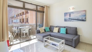 A living room with a sofa, coffee table, and a painting on the wall. - Apartment "Marina Sunny View" with Wi-Fi, Garden & Terrace (Fuengirola)