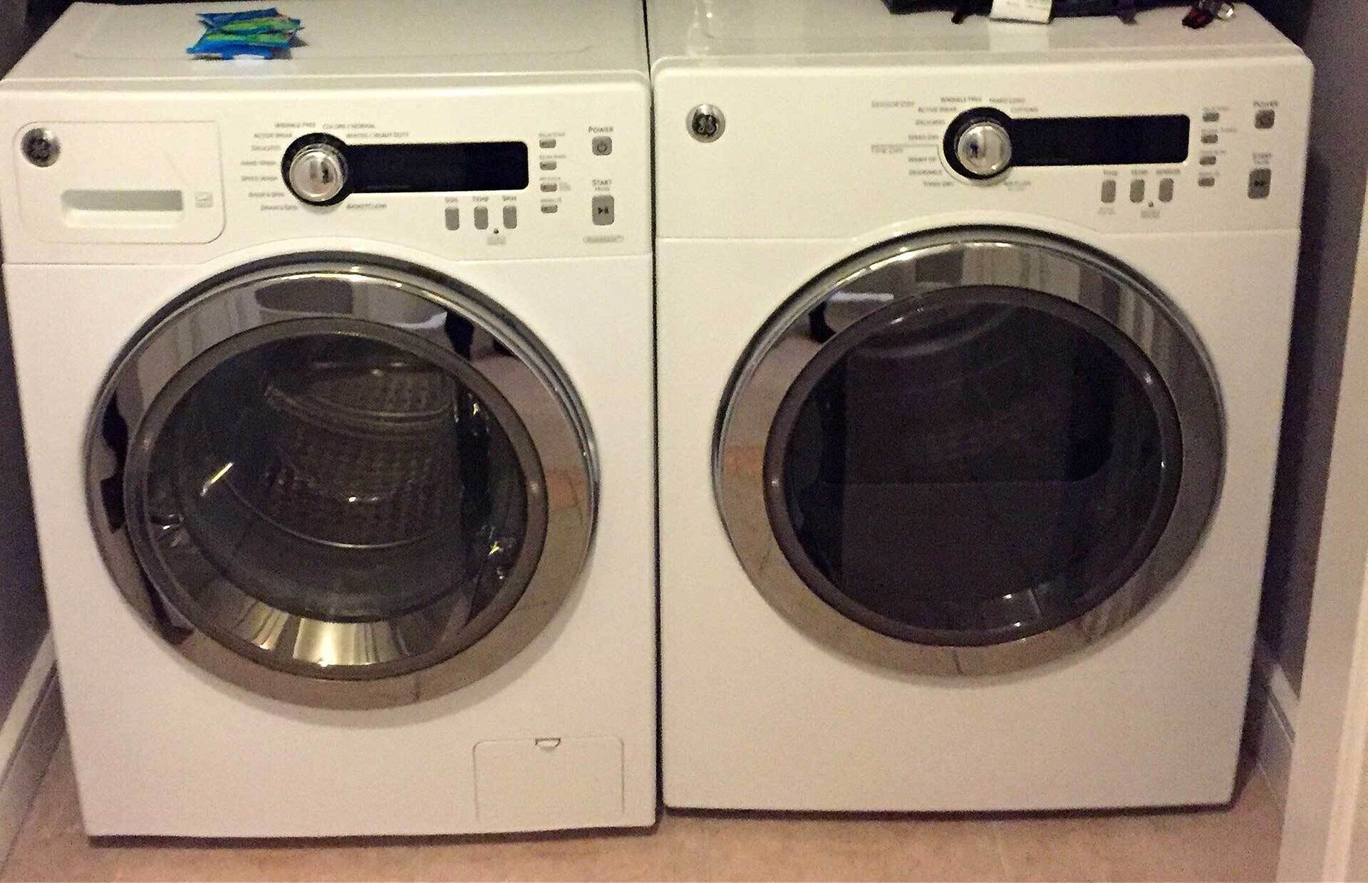 Two white front-loading washing machines side by side.