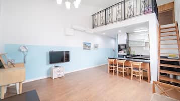 A modern apartment with a kitchen, dining area, and a living room.