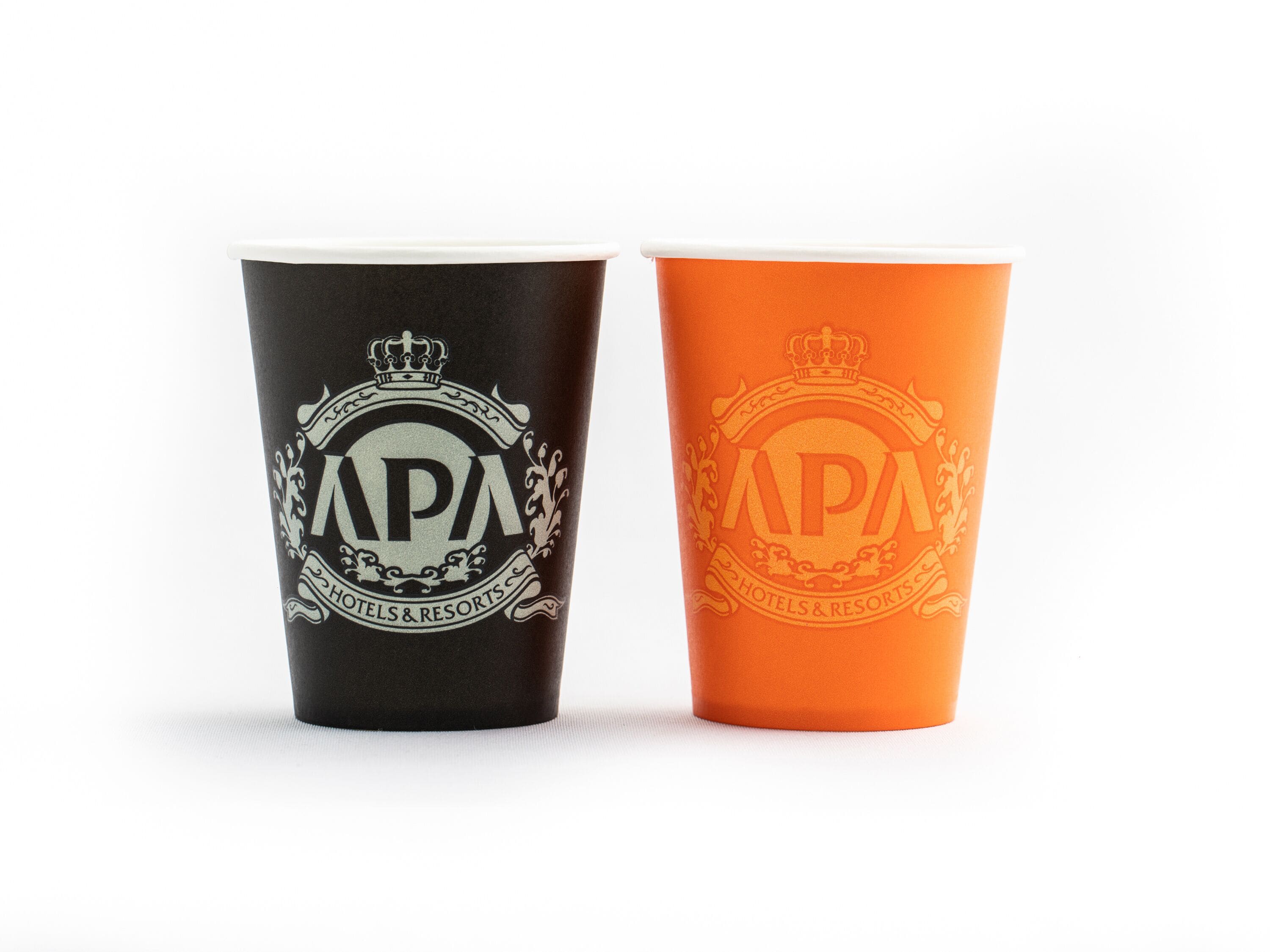 Two cups with the APA Hotels & Resorts logo, one black and one orange.