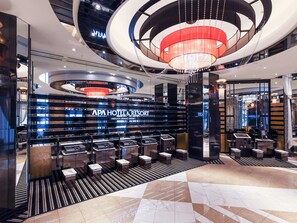 A modern hotel lobby with a central chandelier, a reception desk, and a display of amenities. - APA Hotel & Resort Niigata Ekimae Odori (Niigata)