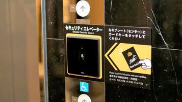 An elevator security system with a card reader and a wheelchair accessibility button.