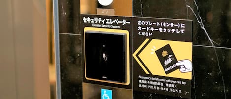 An elevator security system with a card reader and a wheelchair accessibility button.