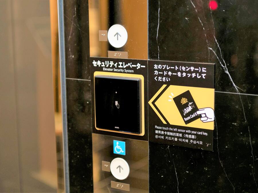 An elevator security system with a card reader and a wheelchair accessibility button.
