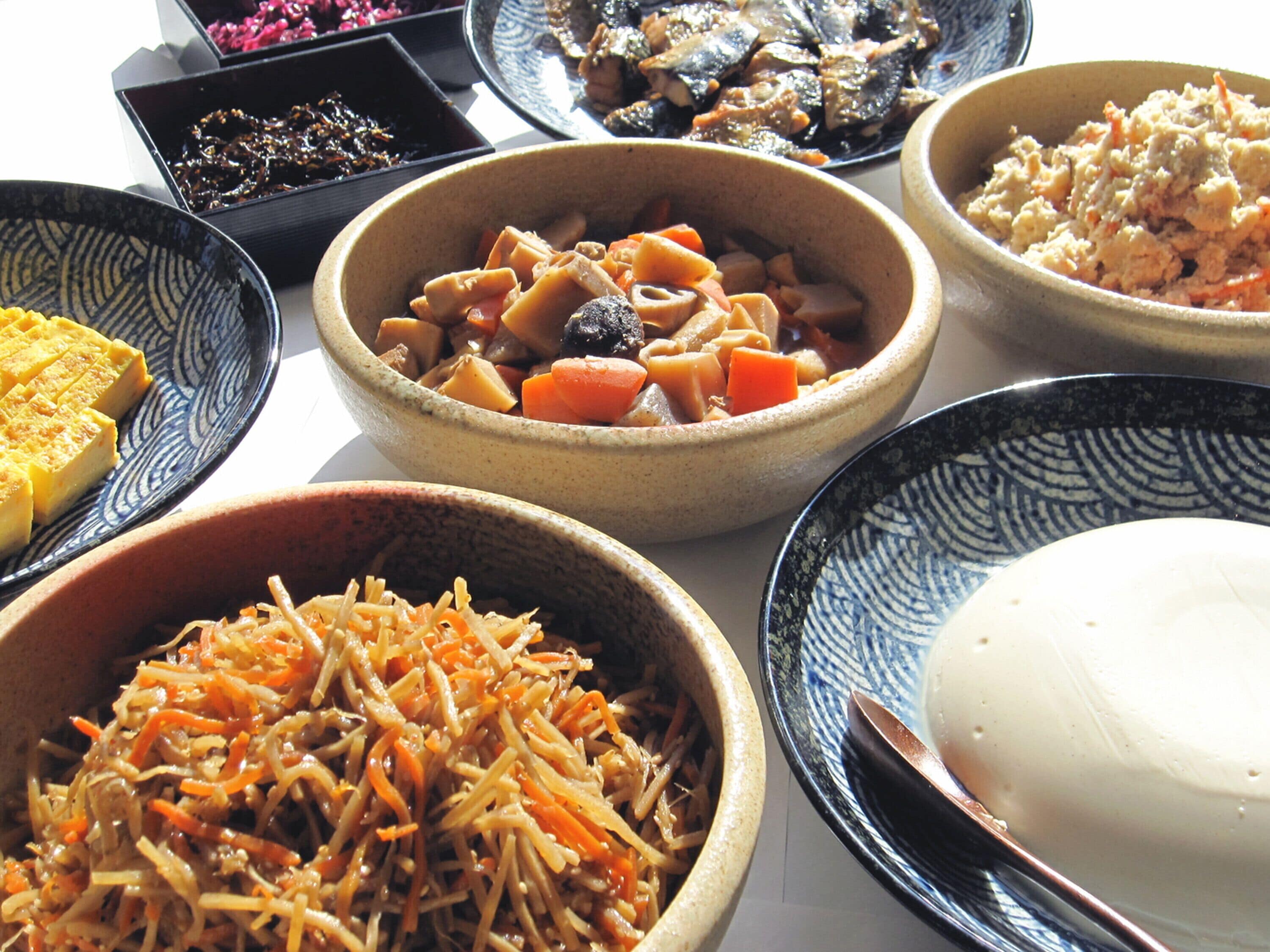 A variety of dishes in different bowls, suggesting a meal setting.